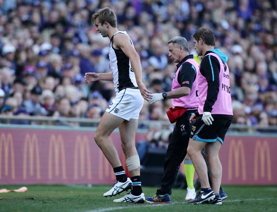 CRUEL BLOW: A disappointed Dougal Howard leaves Domain Stadium in Perth with Port Adelaide staff on Saturday. Picture: Getty Images