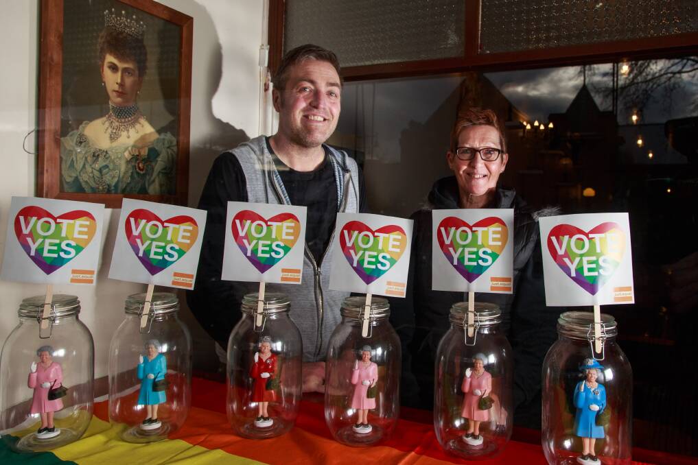 QUEEN'S SUPPORT: Britain has already backed same-sex marriage now the doll version of Queen Elizabeth at Betty Windsor and Sons Coffee Emporium has too, with owner Jarrod Lehman and Toni Johnson. Pictures: SIMON BAYLISS