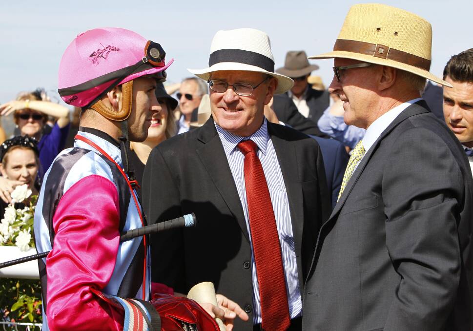 Tye Angland, Wayne Carroll and Greg Carroll discuss the victory of Taraahse in the opening race on Wagga Gold Cup day. Picture: Les Smith