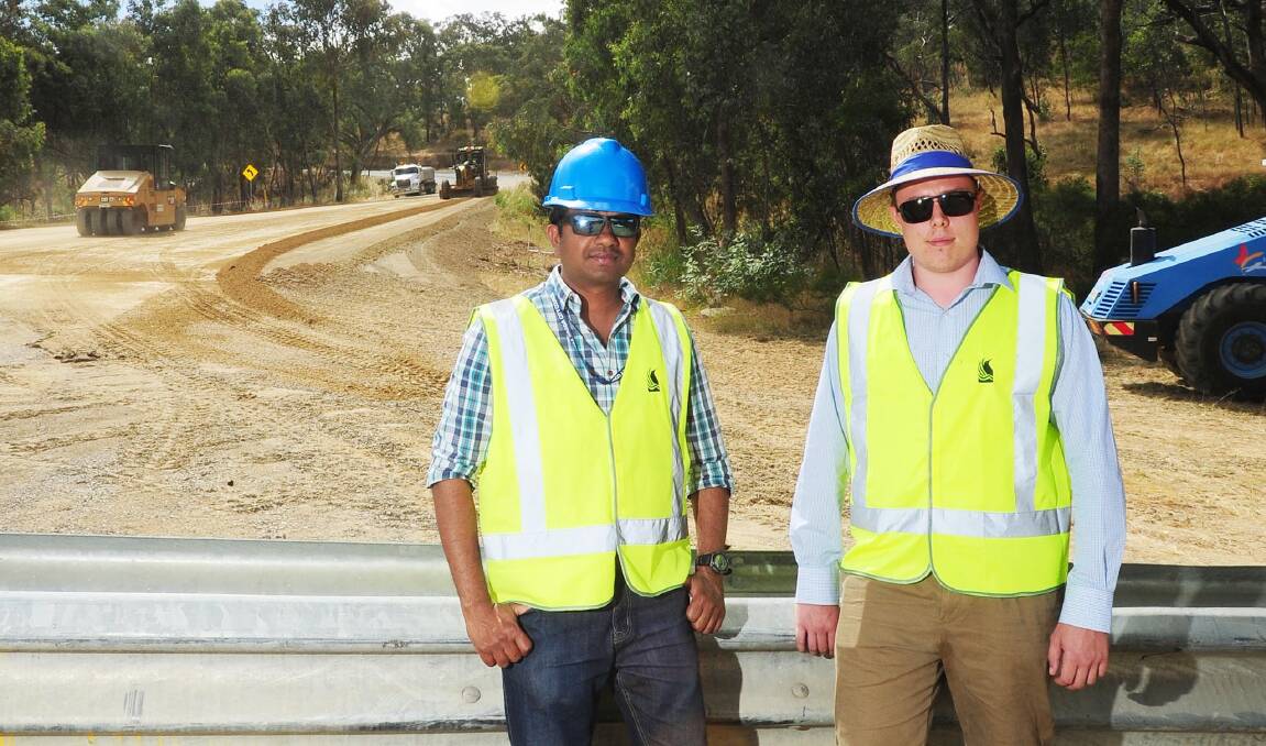 UNDER CONSTRUCTION: Civil engineer Robert Mithilan with cadet engineer Tom Lemerce at the Lord Baden Powell Drive construction site. Picture: Kieren L Tilly