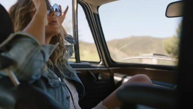 The ad was called "irresponsible" by viewers and slammed for promoting unsafe driving. Photo: Apple Music