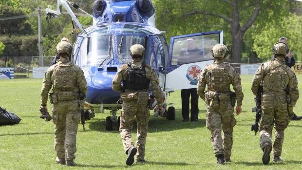 Special Operations Group officers involved in the hunt for the fugitives, in Yea on Friday. Photo: Jason South
