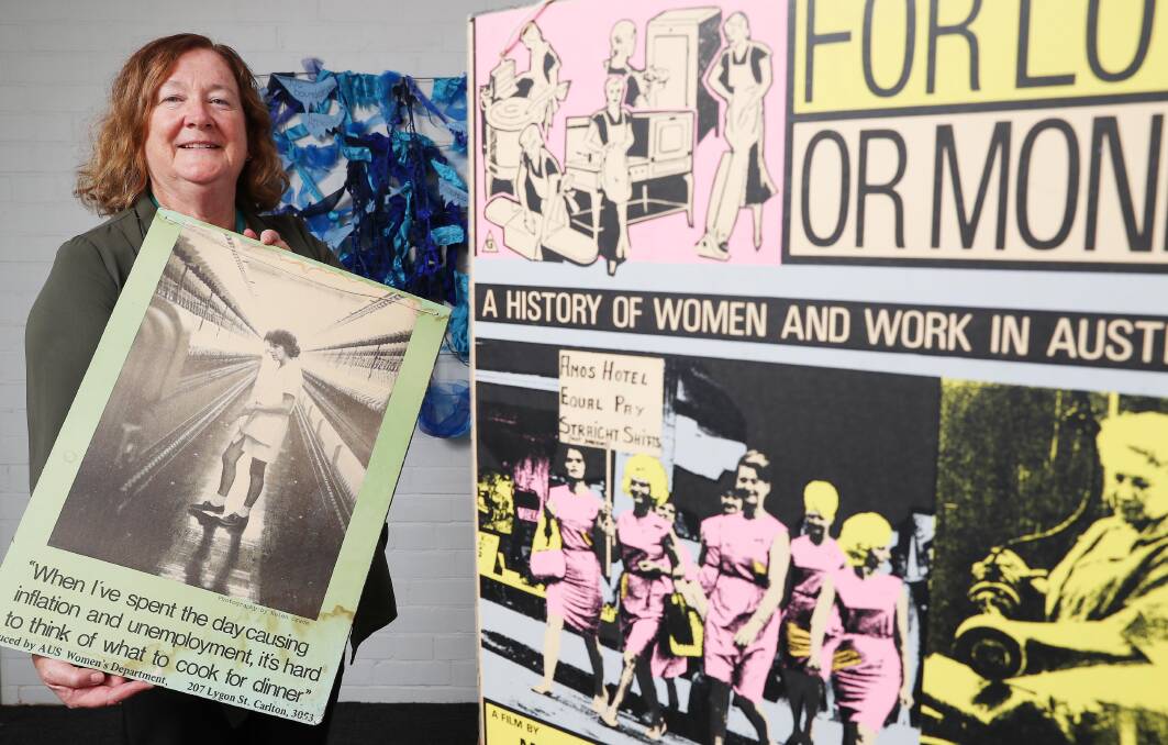 A CELEBRATION: Wagga Women's Health Centre manager Gail Meyer with some of the vintage posters from the 1970s that will appear in the exhibition. Picture: Kieren L Tilly