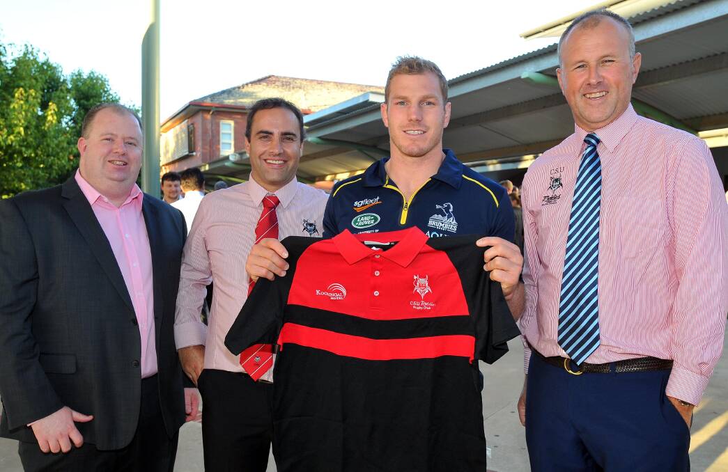 STAR ATTRACTION: CSU officials Alistair Waite, Paul Wood and Paul Spain (right) present Wallabies star David Pocock with a Reddies shirt on Friday. Picture: Kieren L Tilly