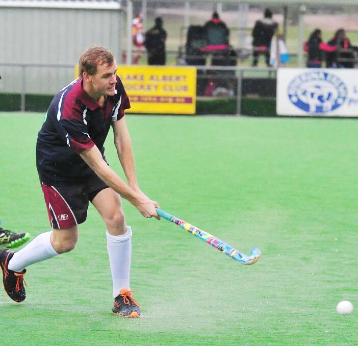 GOING LONG: CSU's Nick Fahey fires the ball down the field as his team returns to winning ways with a 4-0 victory over Cavaliers in men's division one hockey on Saturday. Picture: Kieren L Tilly