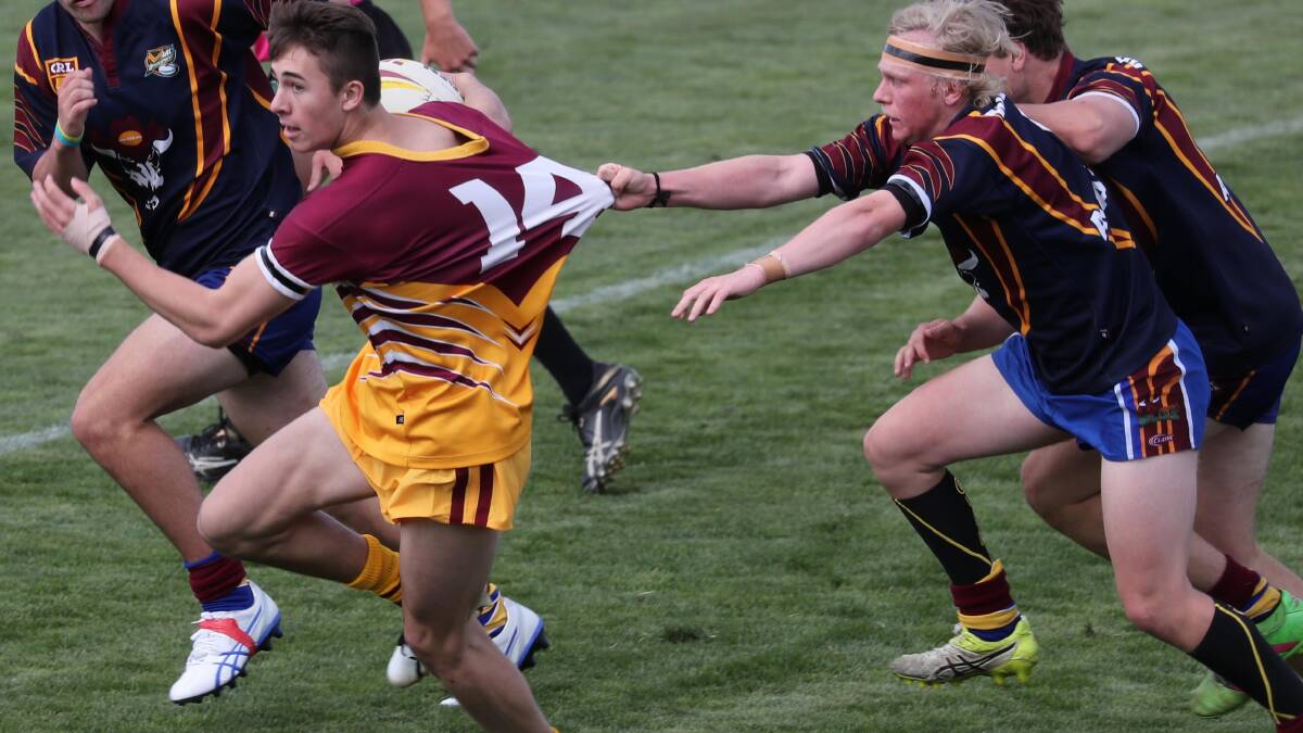Monaro halfback Hayden Bradley tries to drag down Riverina's Zac Rumble under the 17s clash at Equex Centre on Friday. Picture: Les Smith