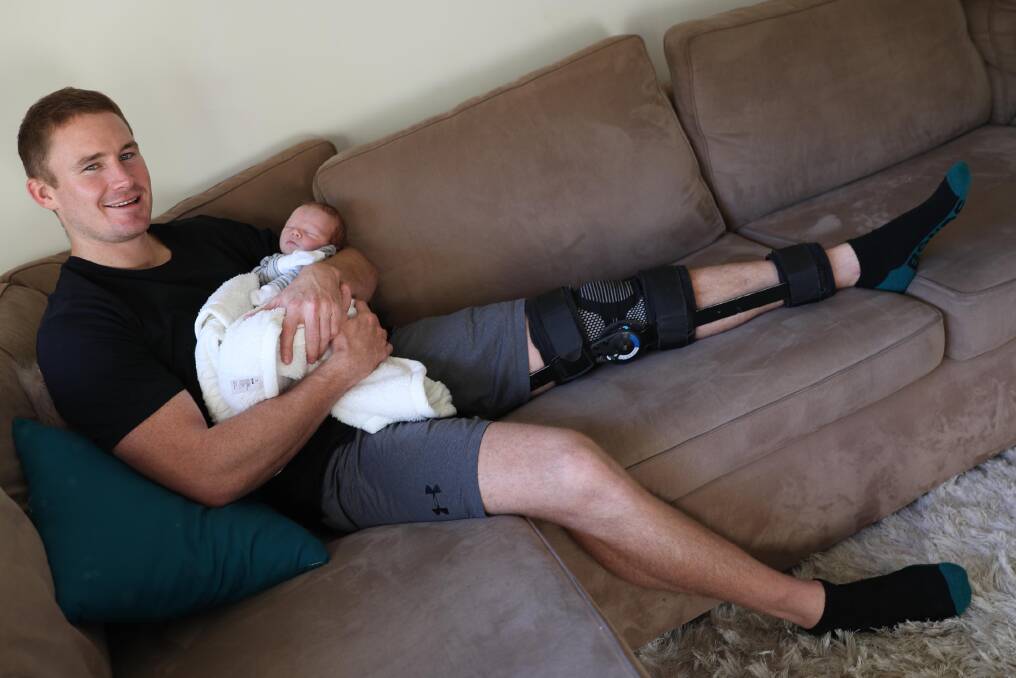 SIDELINED: Star Southcity front rower Nick Skinner, pictured with newborn son Joey, could miss up to six weeks due to a knee injury. Picture: Les Smith