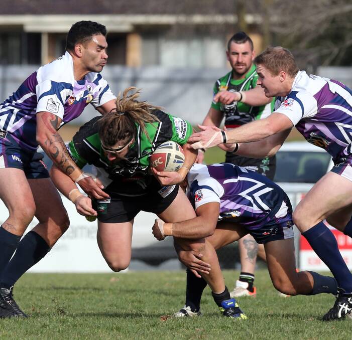 MAN MOUNTAIN: Southcity's Jaye Pukepuke (left), Nick Skinner (right) and Pani Manawatu try to bring down rampaging Albury forward Andrew Cowhan as the Thunder go on to claim a narrow win. Picture: The Border Mail