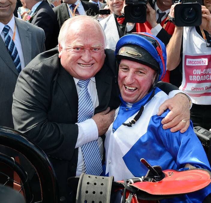 RARE VISIT: Clarry Conners celebrates Oaks success with Jim Cassidy in 2012. Both will be part of the Wagga Gold Cup carnival with Conners to line up Decision Time in the Town Plate on Thursday and Cassidy an ambassador.