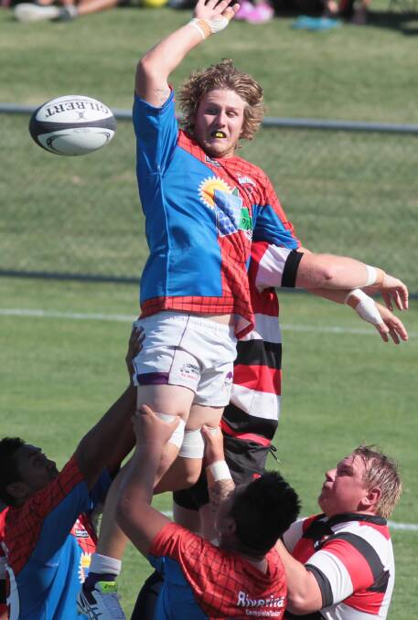 UP IN THE AIR: SIRU Redbacks players Bill Bevan rises above his rivals to win a line out in his team's defeat in the men's curtain-raiser on Saturday. Picture: Les Smith
