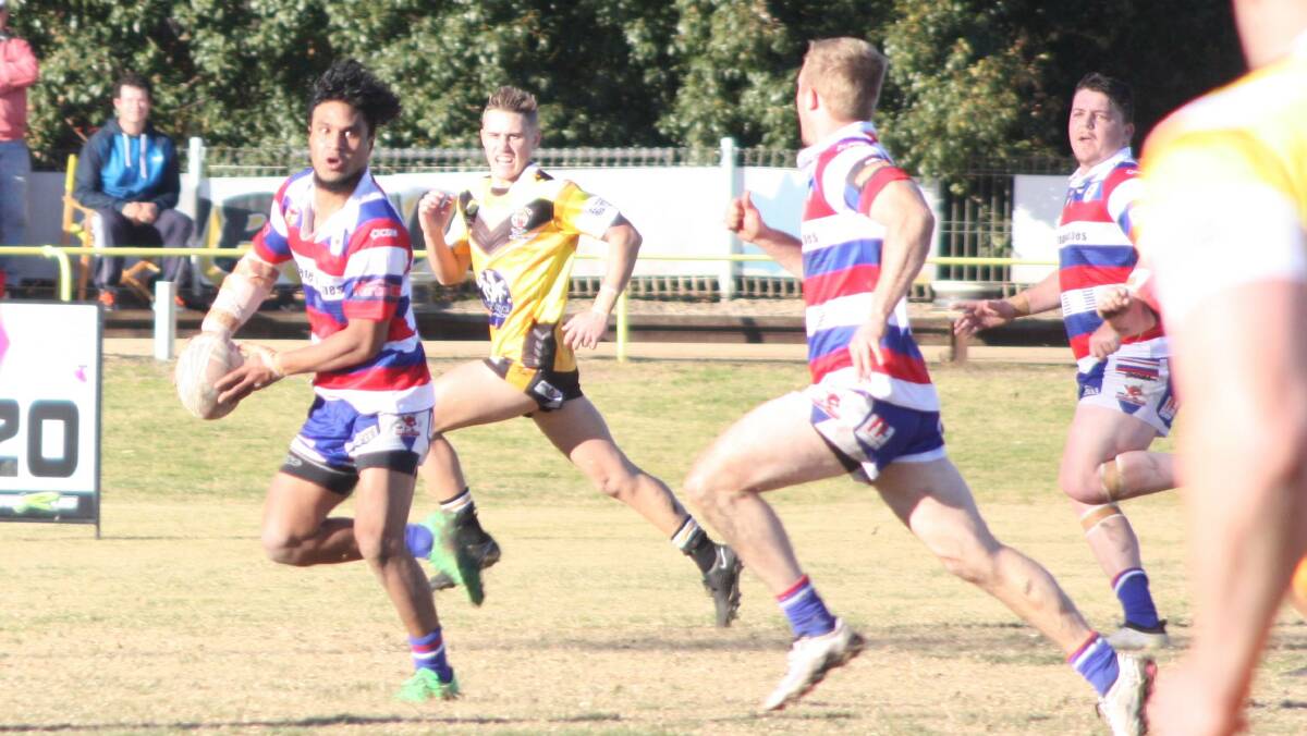 BIG COMEBACK: Ray Talimalie puts Thomas Bush into space as Young scores just before half-time on the way to a 44-16 win over Gundagai at Alfred Oval on Sunday.