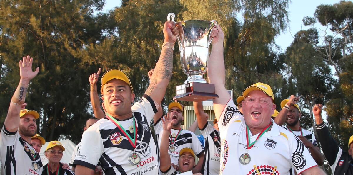 Griffith Black and Whites co-coaches Andrew Lavaka and Craig Morriss raise the Group 20 premiership trophy last month. Morriss has left the Group 20 club to coach Southern Inland team Griffith Blacks.