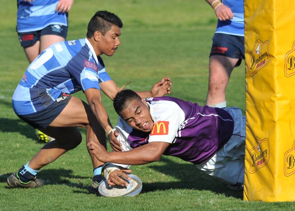 TRY TIME: Waratahs fullback Steve Tracey can't stop Dan Patu from scoring but his three tries helped the Wagga club move into the grand final. 