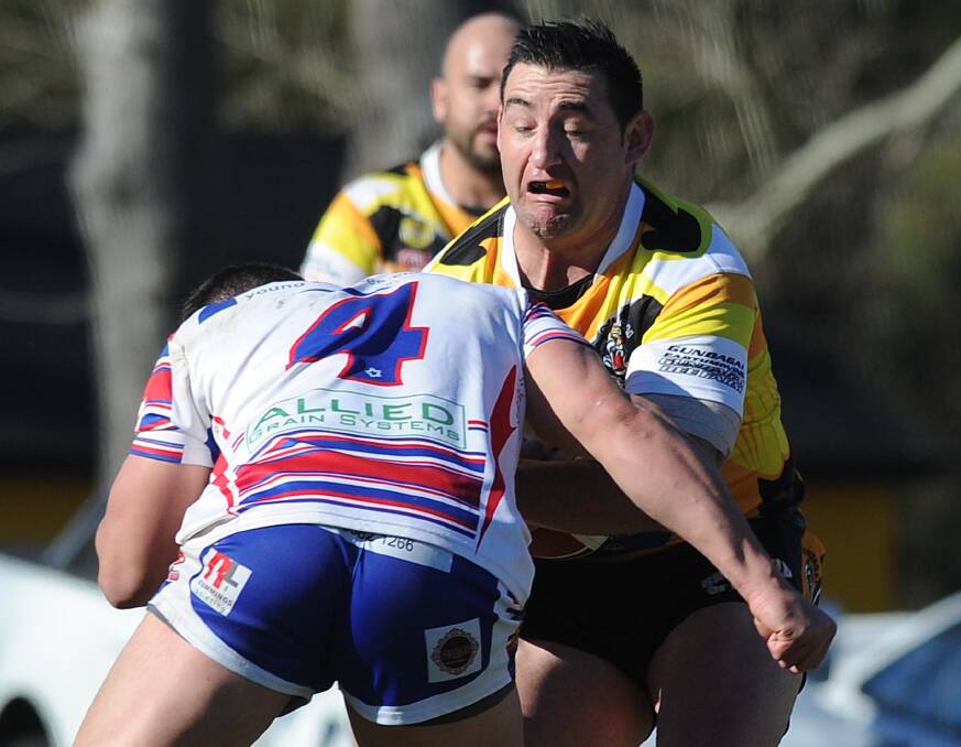 BIG HIT: Gundagai centre Damian Willis feels the heavy tackle of Young counterpart Mitch Ryan during the Tigers big win at Anzac Park on Sunday. Picture: Laura Hardwick