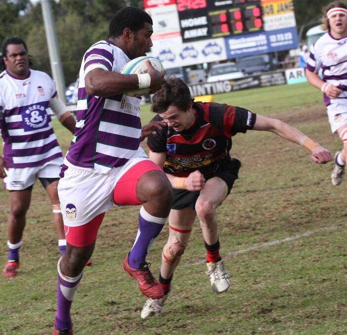 SPEED TO BURN: Centre Adriu Qio Tagilala makes space out wide and looks to charge past Mitch Ivill in Leeton's qualifying final victory over Tumut at Exies Oval on Saturday. Picture: Anthony Stipo