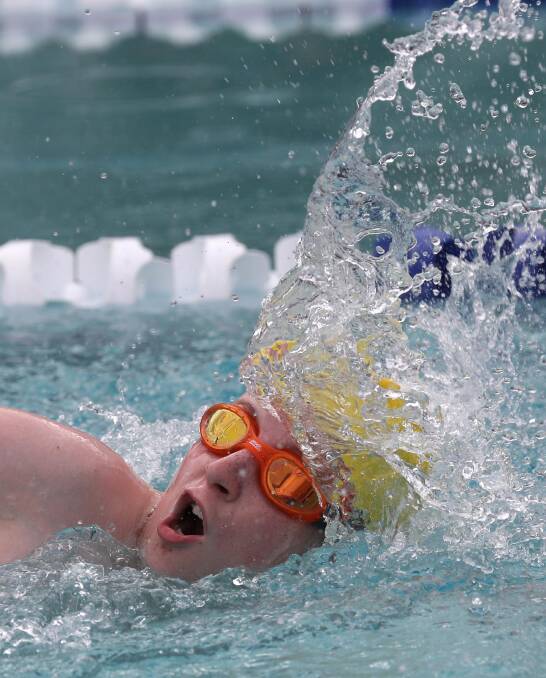 STRONG STROKES: Aidan Jones, 14, competes in a 50m freestyle race at the Mater Dei Catholic College swimming carnival at Oasis on Thursday night. Picture: Les Smith