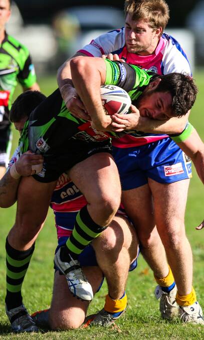 CHARGING AHEAD: Albury's Jon Huggett pushes through Junee's Rhys Clemson as the Thunder just fell short of a remarkable comeback. Picture: The Border Mail