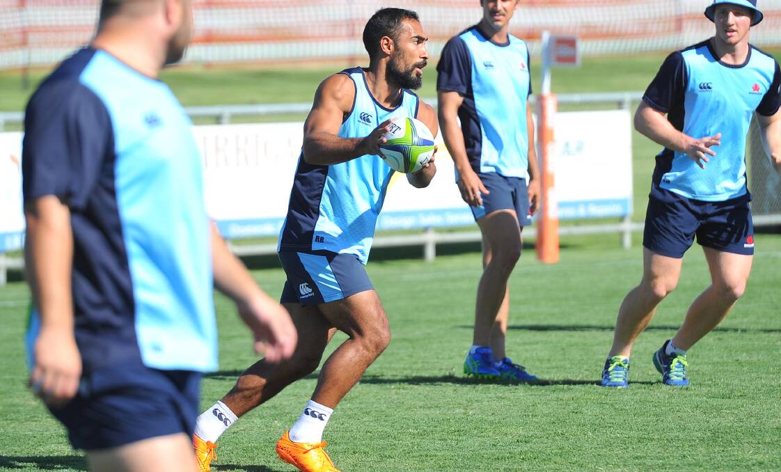 FRESH TEST: Reece Robinson gets a feel for the ball in NSW Waratahs' training session on Friday ahead of his debut for the club. Picture: Kieren L Tilly