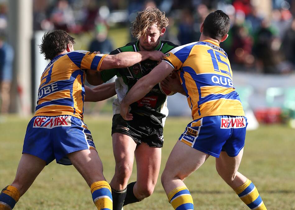 ON THE CHARGE: Albury forward Dave Cowhan is met by Junee defenders Trent Schubach (left) and Rick Judd on Sunday. Picture: The Border Mail