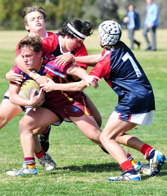 ALL WRAPPED UP: Mater Dei Catholic College's Jacob Levy tries to get out of some heavy Kildare Catholic College defence in his team's Riverina Cup final loss on Tuesday. Picture: Kieren L Tilly