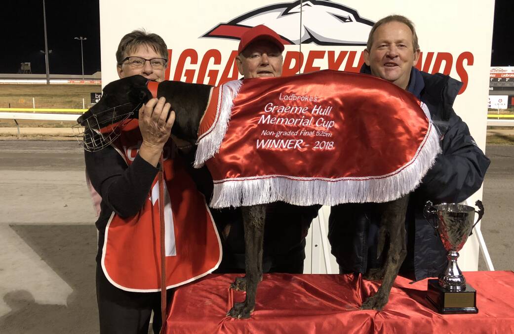 CUP WIN: Wallendbeen trainer Jack Roy (centre) celebrates Gunshot Ridge's win in the Graeme Hull Memorial Cup with owners Angela Della Bosca and Graham Sheather on Friday night. Picture: Courtney Rees