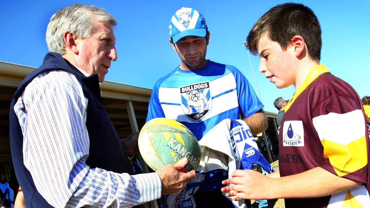 STAR POWER Steve Mortimer signs some autographs for Beelbangera Public School student Dante Maccagnan and his father John on Wednesday. Picture: Les Smith