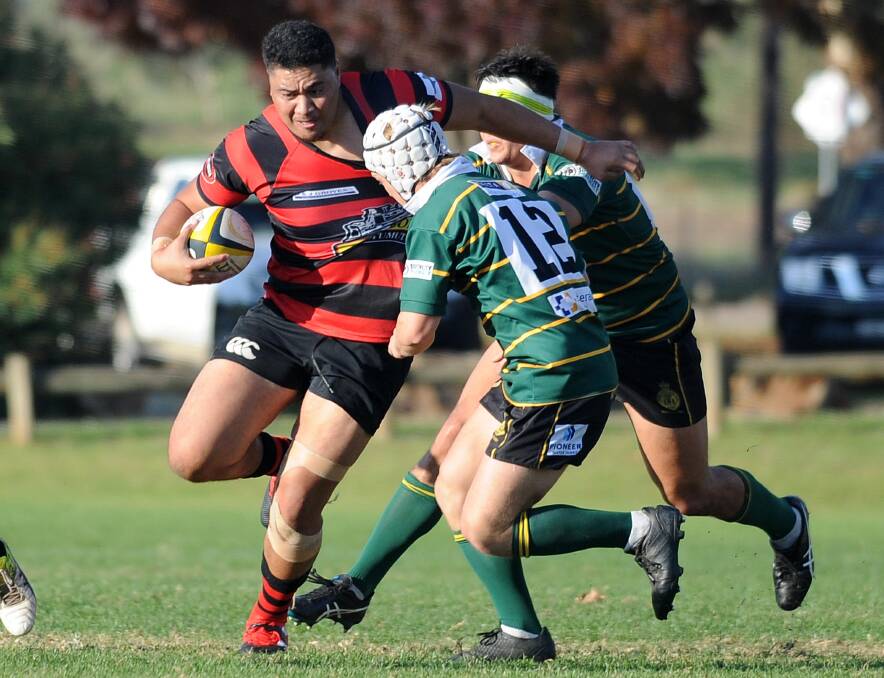 CHARGING AHEAD: Ag College defenders Cameron Duffy and Duncan Woods look to bring down Tumut centre Phil Tavai in the Bulls' win at Beres Ellwood Oval on Saturday. Picture: Laura Hardwick