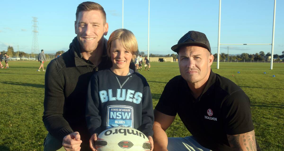 INSPIRATION: NSW supporter Jesse Black, 5, shares a moment with former State Of Origin players Brent Tate and Matt Cooper during a clinic at Parramore Park on Tuesday.