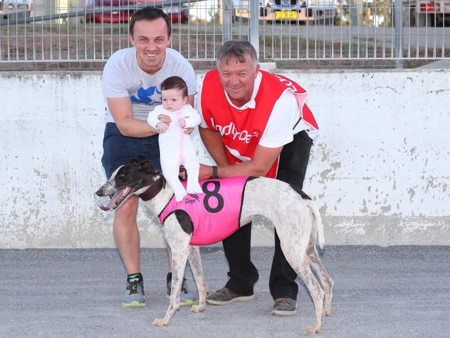 A FAMILY AFFAIR: Abram, Lily, nine weeks, and Paul Meredith celebrate Guitar Girl's win in the first race at Wagga on Friday night. Picture: Kieren L Tilly