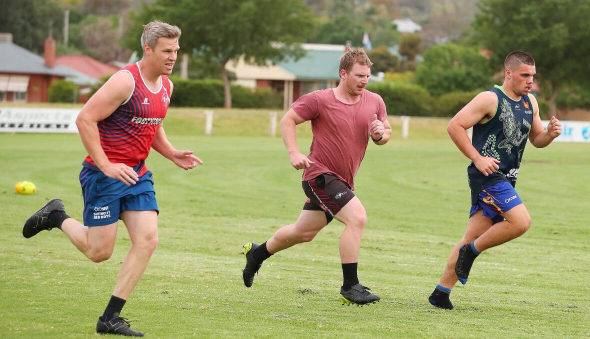 PUSHING HARD: Southcity captain-coach Kyle McCarthy (centre) at the Bulls training run with Simon Parr and Brody Tracey. Picture: Kieren L Tilly