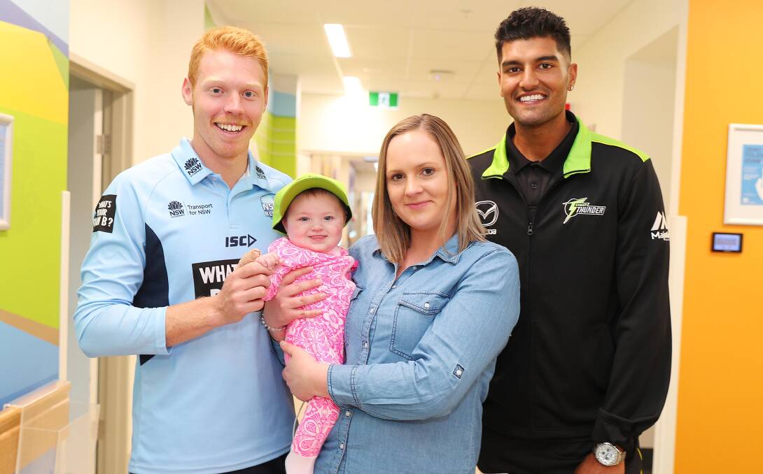 NEWEST FAN: Liam Hatcher (left) and Gurinder Sandhu (right) with Evie Lawrence-Winslett, 6 months, and her mum Carly Lawrence, at Wagga Rural Referral Hospital.