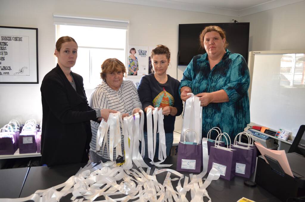 Wagga Women's Health Centre's Melissa Sanders, Mary-Ellen Bradley, Johanna Elms and Jessie Roberts with their white ribbons. Picture by Taylor Dodge