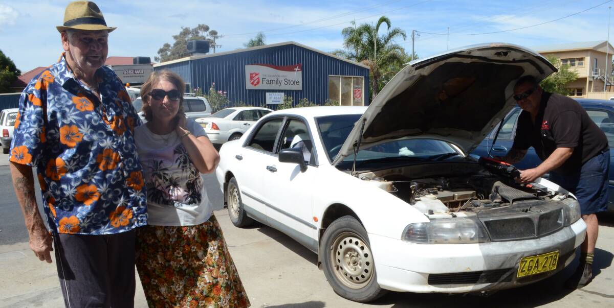 GHOST IN THE MACHINE: Milvale couple Bob and Zelma Parkes with their white Mitsubishi Magna, which they claim is haunted.