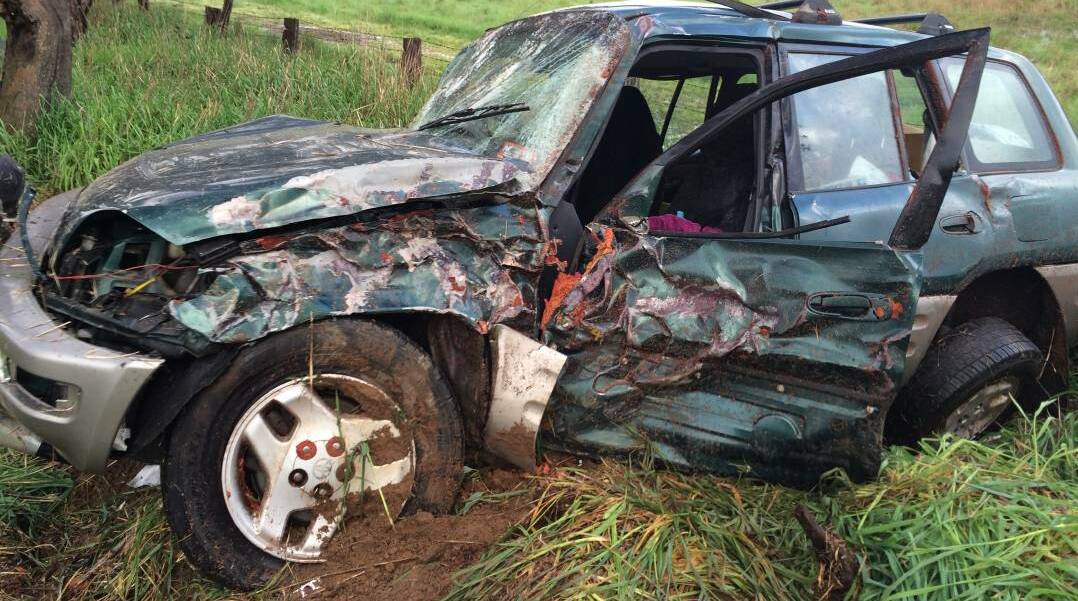 WRITE-OFF: The wreck of a car after veering off the road at Wallendbeen on Thursday morning.