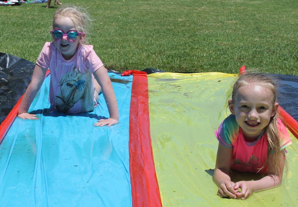 Charlotte Terry and Mackenzie Close have a great time on the slip n slide at the Cootamundra Pool Party last year.