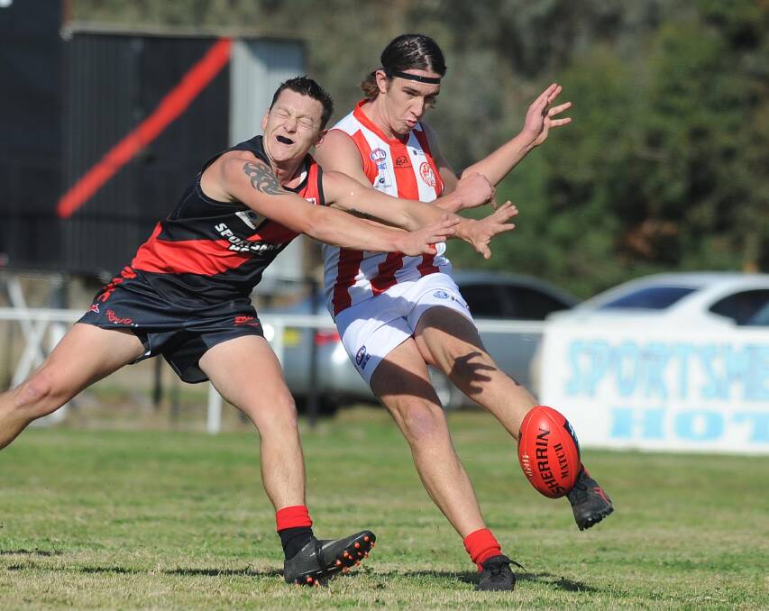 IN VAIN: CSU's Jack Thompson-Gardener gets a kick away under pressure from Jackson Moye during the Bushpigs' hammering at the hands of Marrar on Saturday. Picture: Laura Hardwick