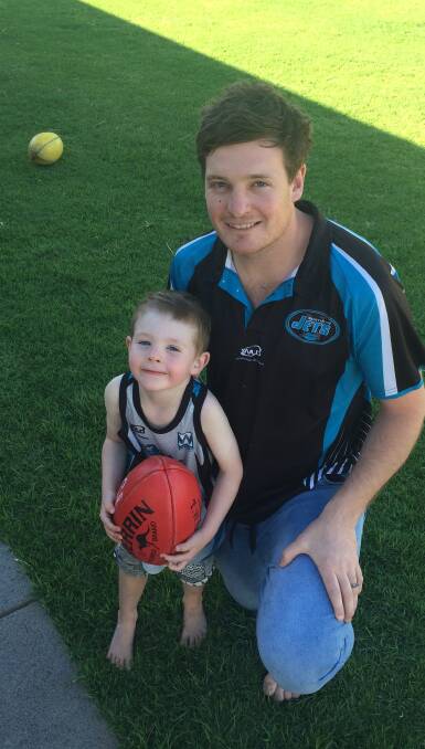 NEW JOB: Northern Jets coach Mitch Robinson with son Charlie, 3. The defender will make his coaching debut with the Farrer League club next year.