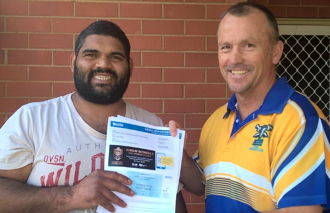 ALL SMILES: George Byers, left, receives his four NRL grand final tickets from Group Nine junior rugby league secretary Mick Kirkman this week. 