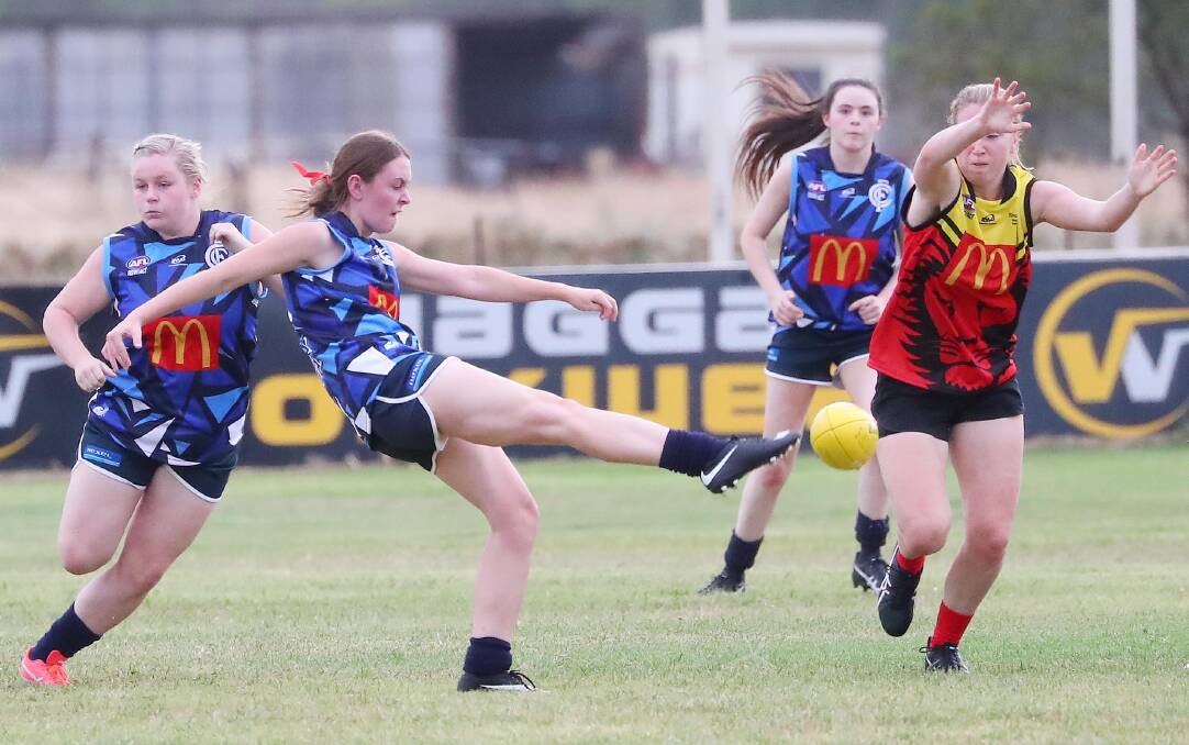 WOMEN'S FOOTY IN FOCUS: Cootamundra's Emily Poulton gets a kick in against Riverina Lions in the opening round of the inaugural Southern NSW AFL Women's league early this year. 