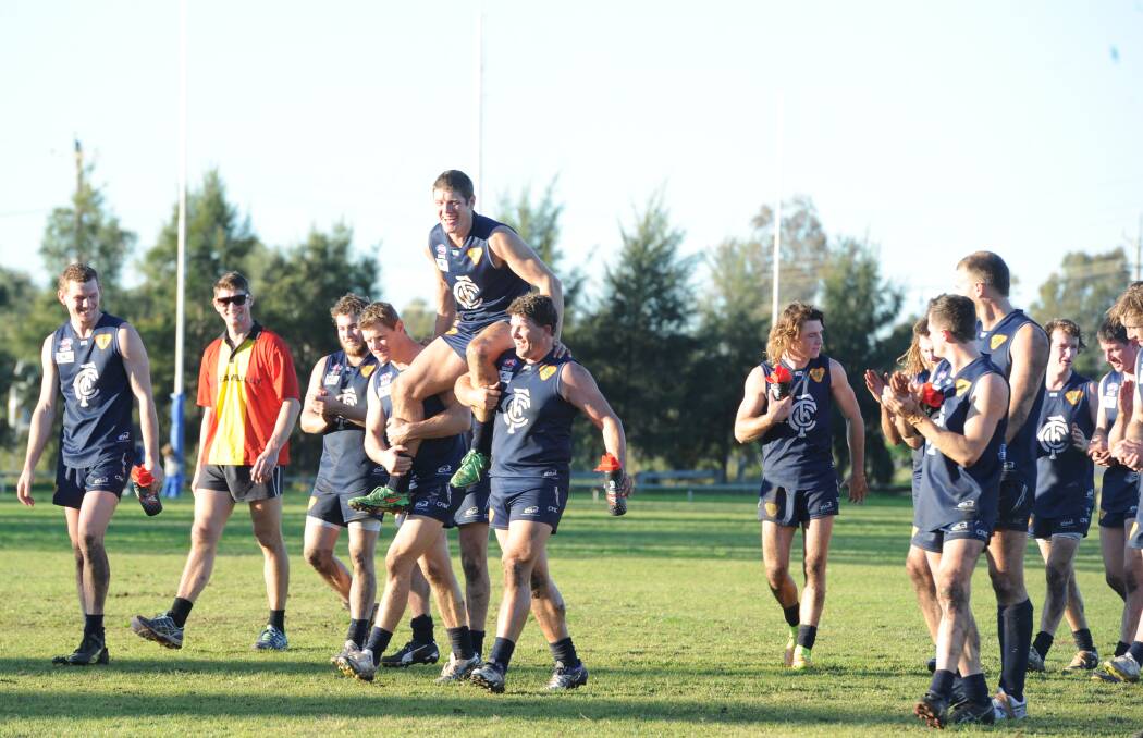 Carl Pound is carried off by teammates after his first home game since playing his 250th game for the club a fortnight ago. Picture: Riley Krause.