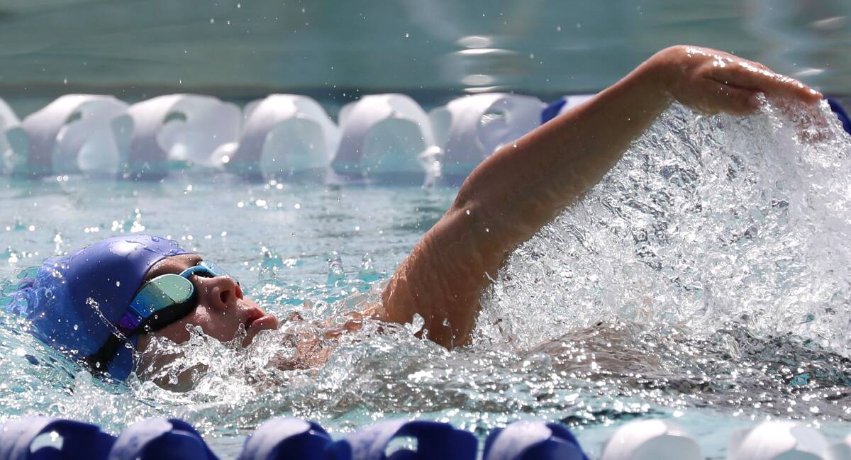 SET OF SIX: Jones Russell on his way to another record in the 50m backstroke at the Wagga Christian College swimming carnival. Picture: Les Smith