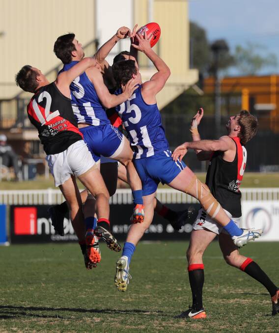 TOUGH DAY: Temora forwards Matt Harpley and Matt Wallis both go up, under pressure from Mitch Taylor (left) and Jesse Cunningham. Picture: Les Smith