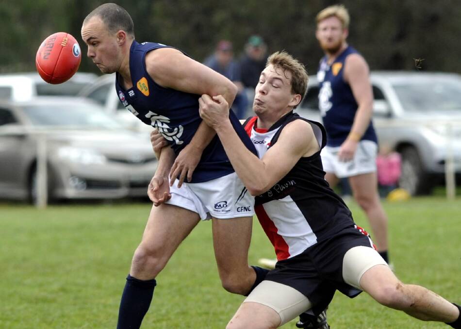 HOLDING ON: North Wagga defender Alex Hay gets a good grip on Coleambally's Tom Fuller in Sunday's semi-final at Collingullie. Picture: Les Smith