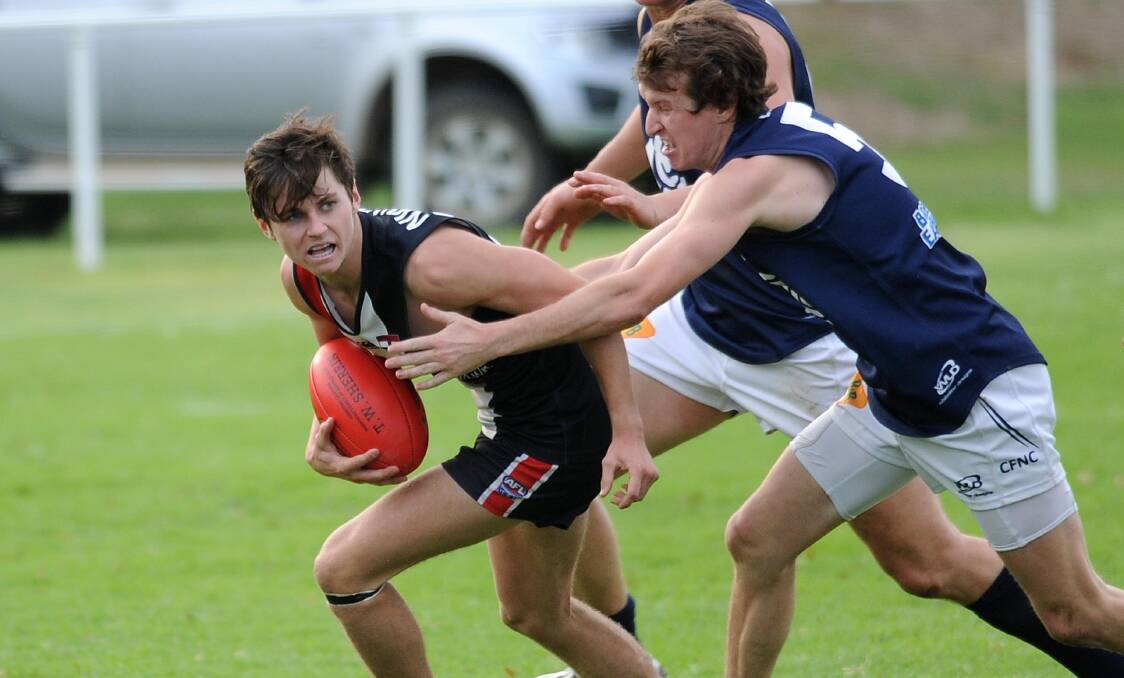 TOUGH OUTING: North Wagga's Nathan Dennis under pressure from Coleambally's Blake Jones at McPherson Oval. Pictures: Laura Hardwick