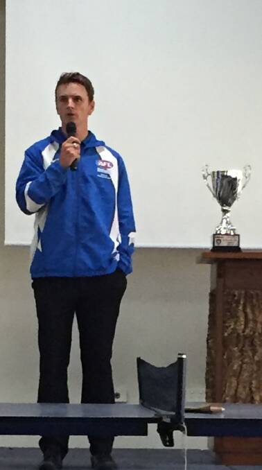 VICTORIOUS: Farrer League coach Ryan Forsyth accepts the trophy.