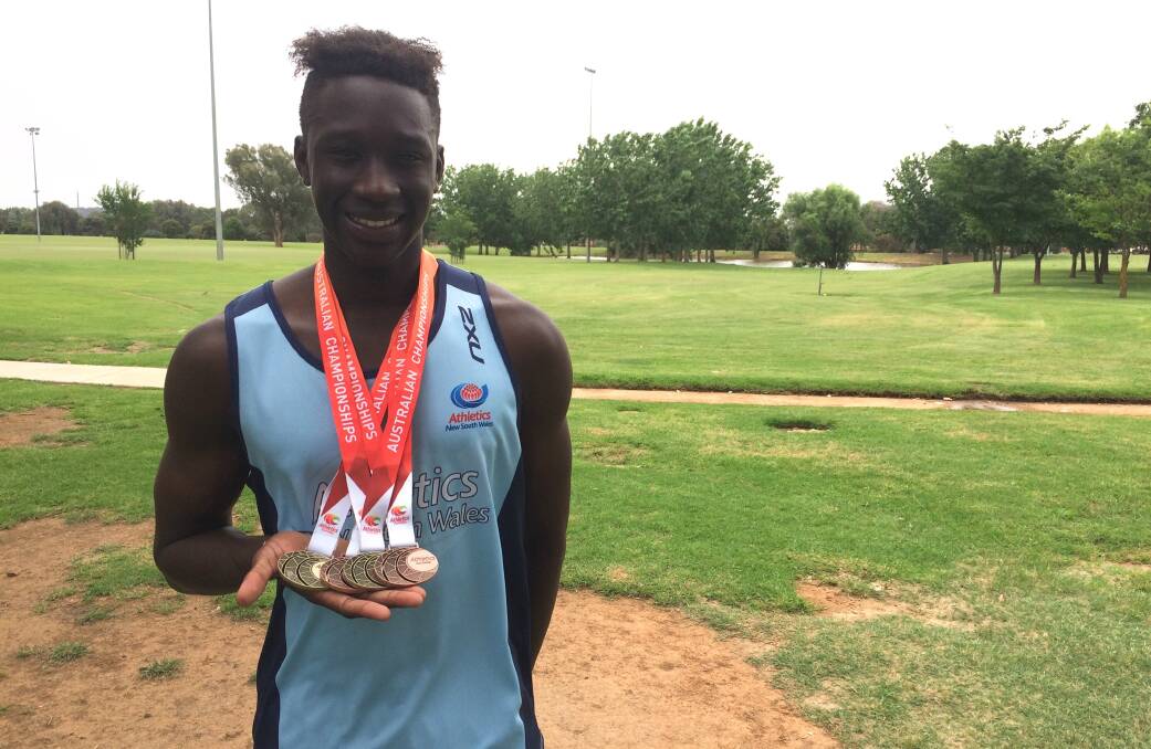 FOUR MORE: Godfrey Okerenyang with his medal haul from the Australian All Schools athletics championships in Adelaide. Picture: Peter Doherty