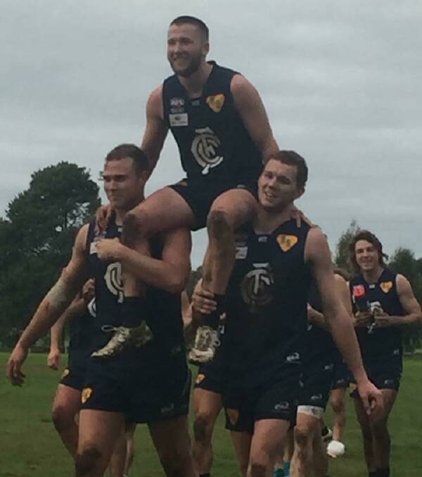 100 CLUB: Todd Clark is chaired off by twin towers Josh Hamilton and Kodie O'Malley after his 100th game. 