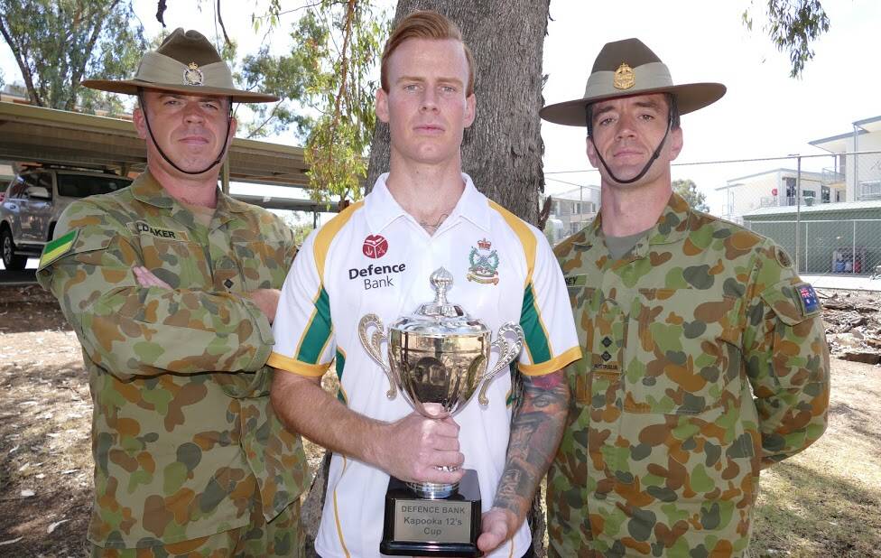 K-SERIES: Kapooka AFL 12s players Captain Aaron Oldaker, Lieutenant Robert Cameron and Lieutenant Jess Creasey, with the cup which is up for grabs by local teams.