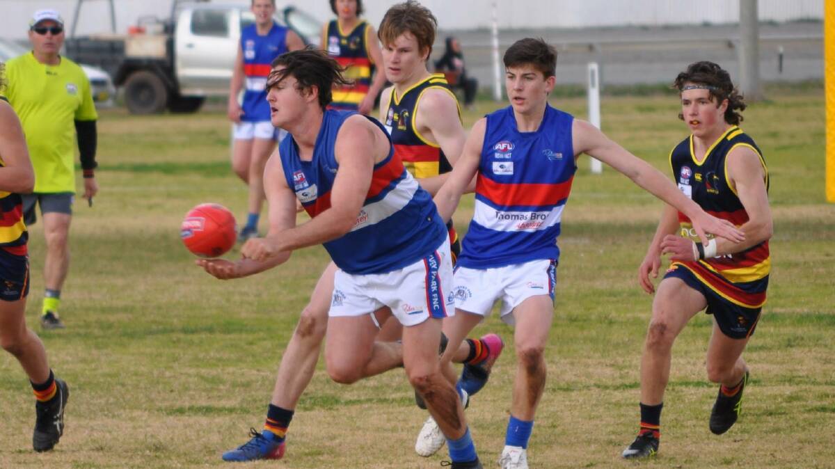 ALL SET: Turvey Park's Cody Bramich fires out a handball as Ben Richards shepherds. The Bulldogs under 17s will take on Collingullie-Glenfield Park in Saturday's grand final at Narrandera. Picture: Simone Harmer
