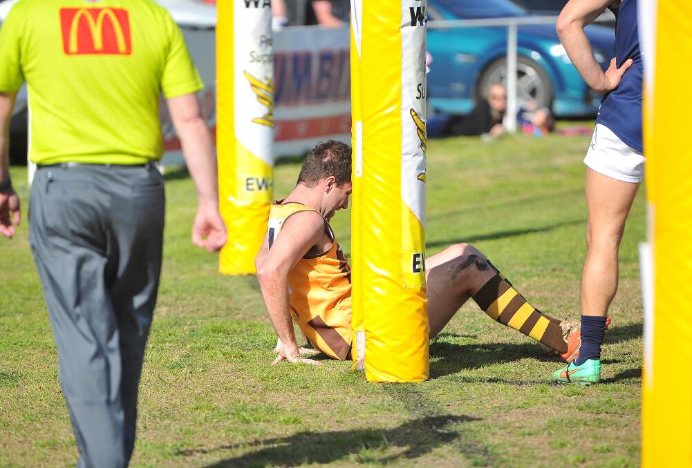 Geppert is slow to get back up after slamming heavily into the goal-post when taking a mark that led to his second goal. Picture: Kieren L Tilly